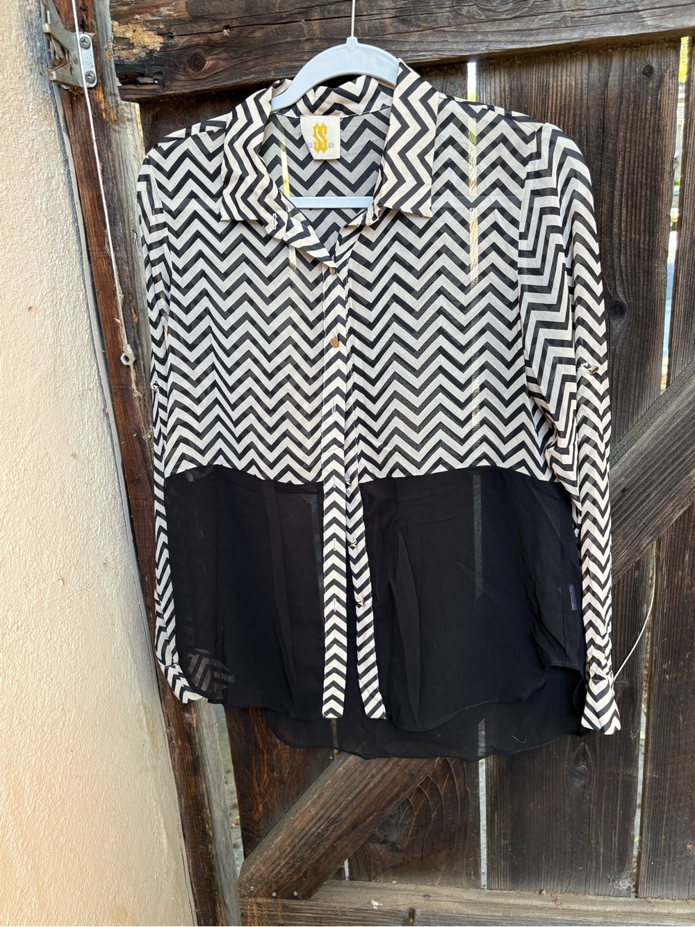 black and white chevron-patterned long-sleeve button-down blouse